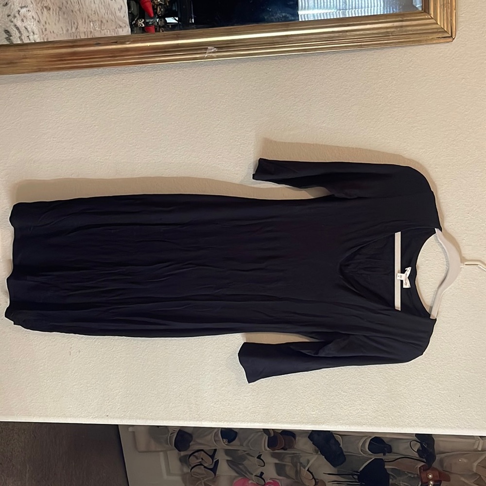 3/4 arm length, v neck, simple black dress.